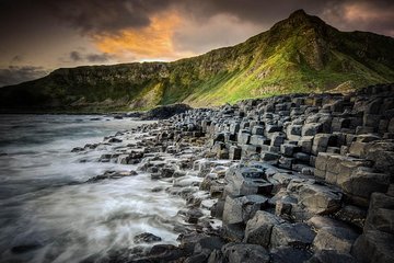 The giants causeway at dusk looking from the sea to the cliffs over the stones